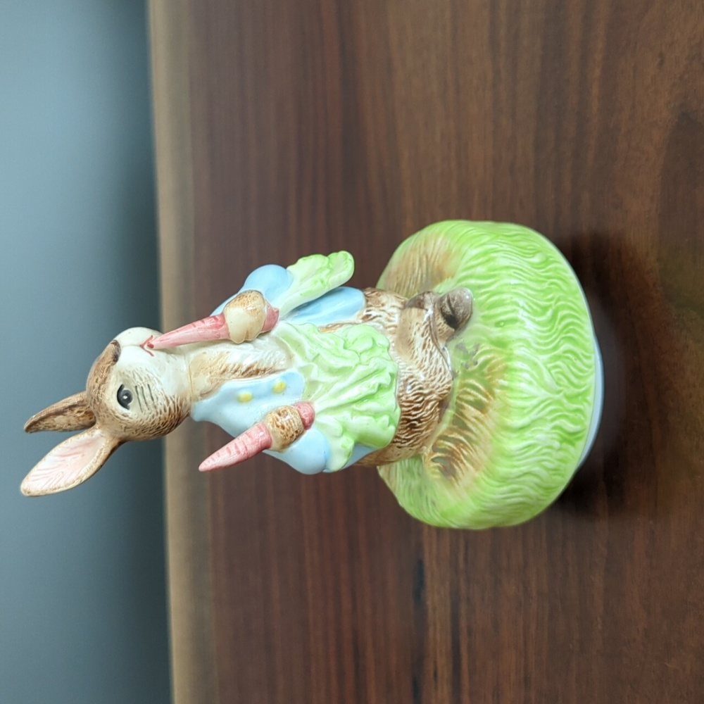 Schmid porcelain music box. Peter spins when the music plays, It's a Small World